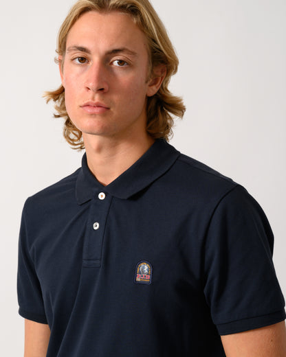 close up of a model wearing a Parajumpers Wellington Mens Short Sleeve Polo in Blue Navy 316