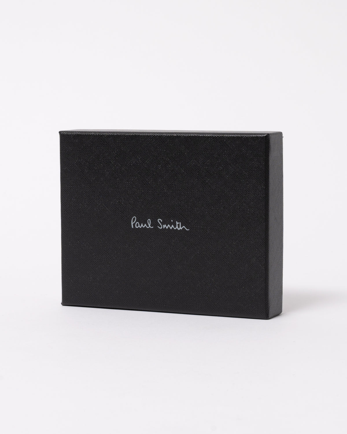 studio photograph showing the packaging of a Paul Smith Mens Zebra Badge Billfold Wallet in 79 Black