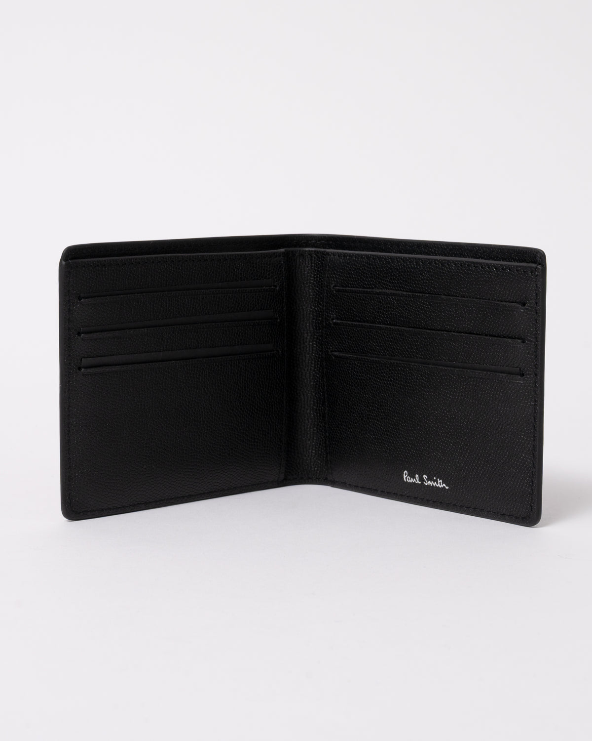 studio photograph showing an open Paul Smith Mens Zebra Badge Billfold Wallet in 79 Black