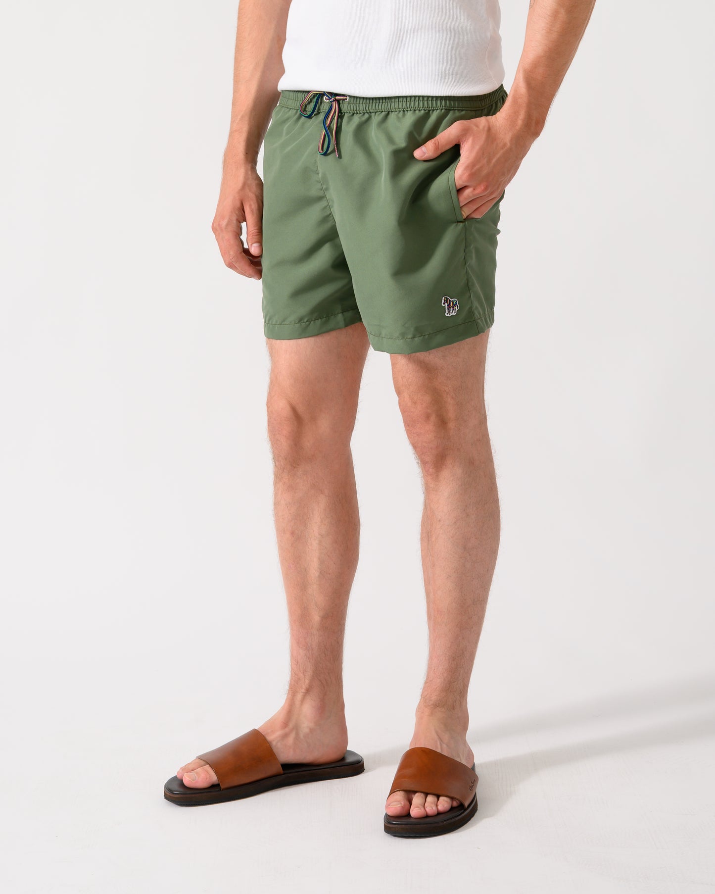 model wearing a pair of Paul Smith Mens Zebra Logo Swim Shorts in 35A Green