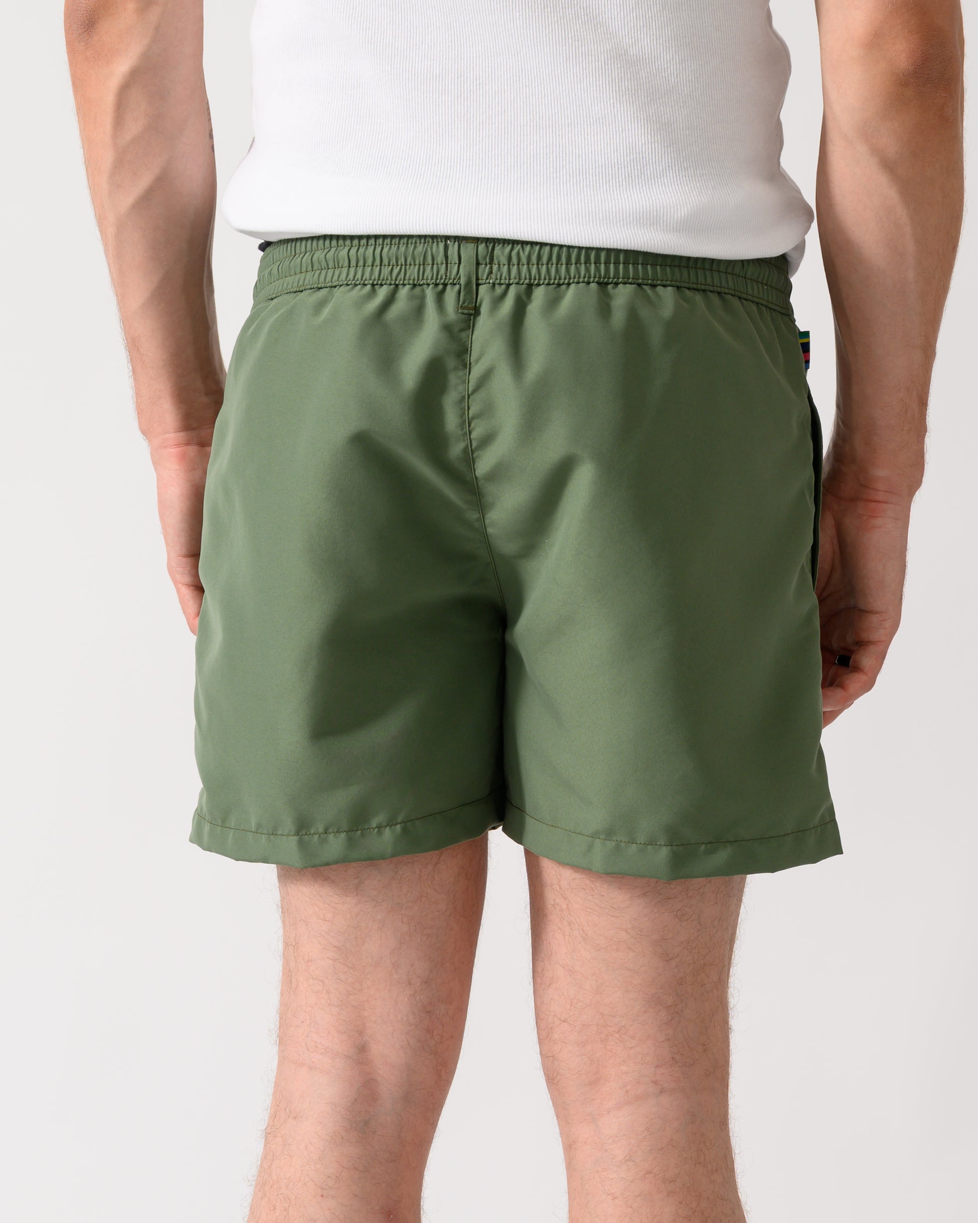 back shot of a model wearing a pair of Paul Smith Mens Zebra Logo Swim Shorts in 35A Green