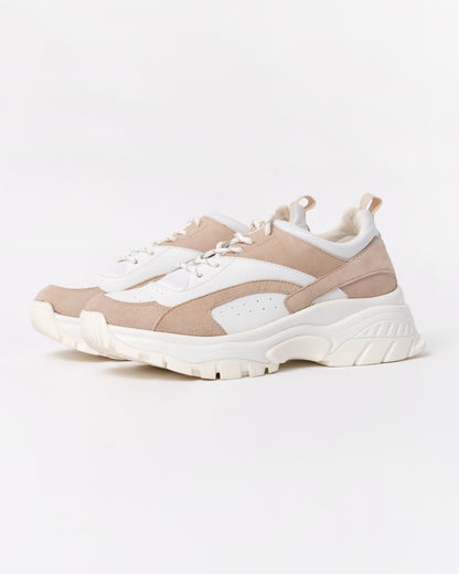 Beige and white sneakers on a light gray background