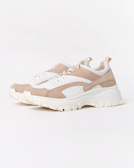 Beige and white sneakers on a light gray background