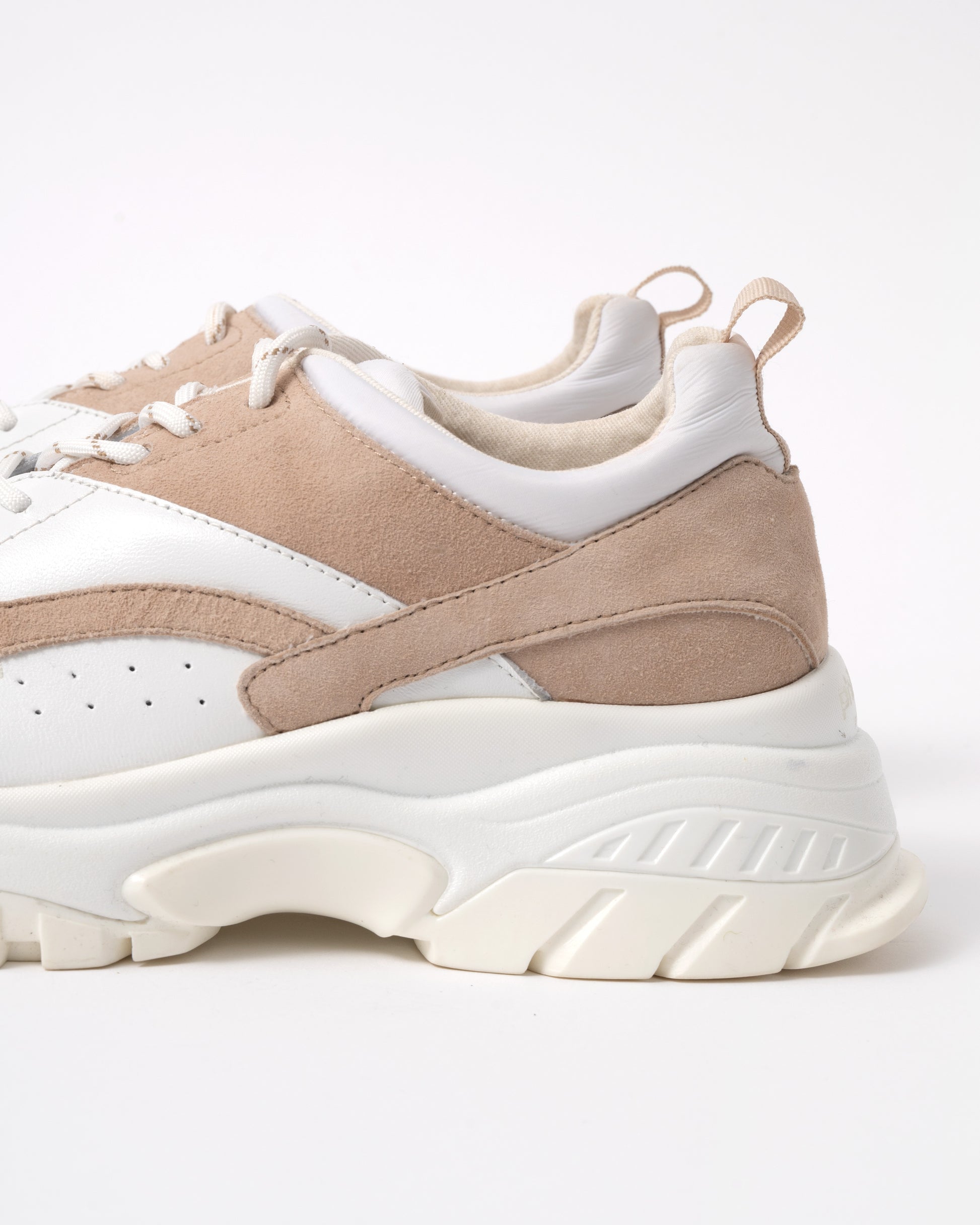 Beige and white sneakers on a white background