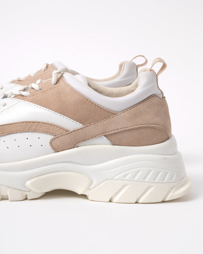 Beige and white sneakers on a white background