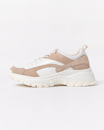 Beige and white sneaker on a light gray background