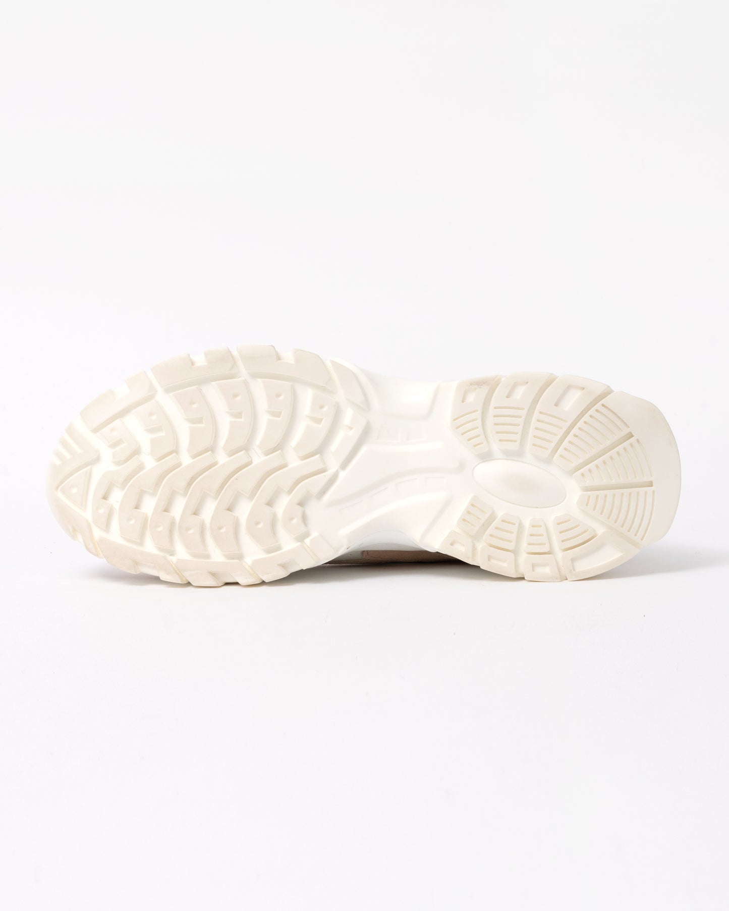 Close-up of a white sneaker sole on a light gray background
