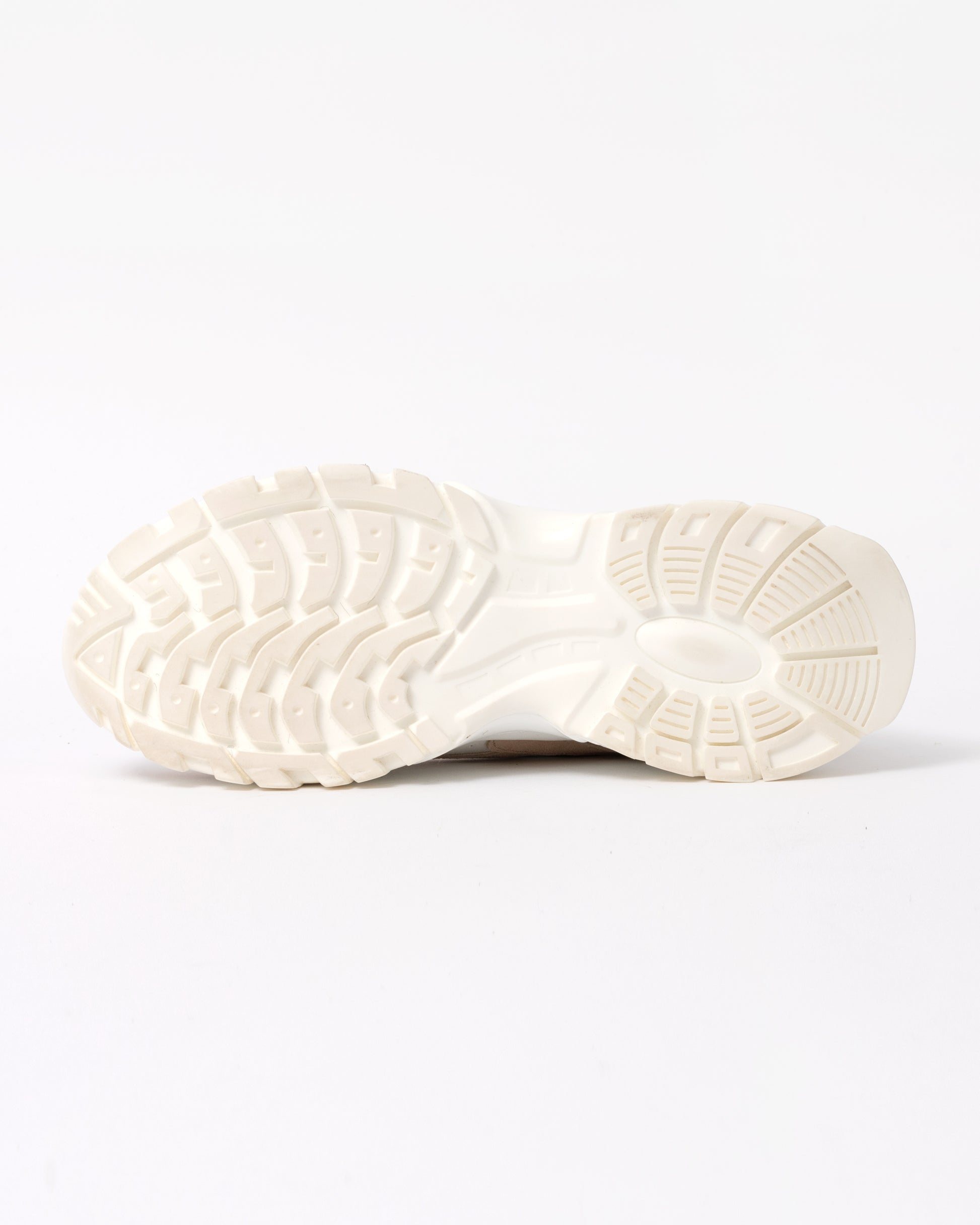 Close-up of a white sneaker sole on a light gray background