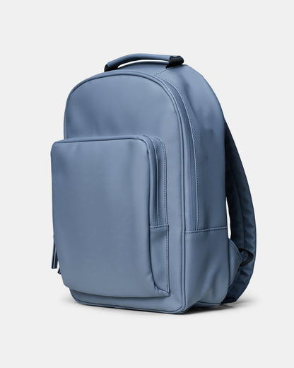 side shot of Rains Book Daypack in 172 Blue Dusk