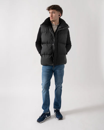 full length of model wearing a Rains Boxy Unisex Puffer Vest