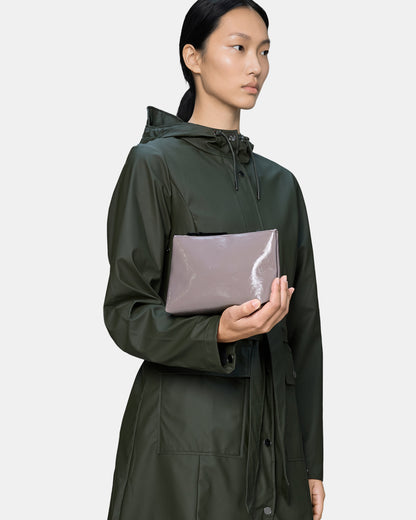 model holding a Rains Cosmetic Bag in 194 Cinder Glaze