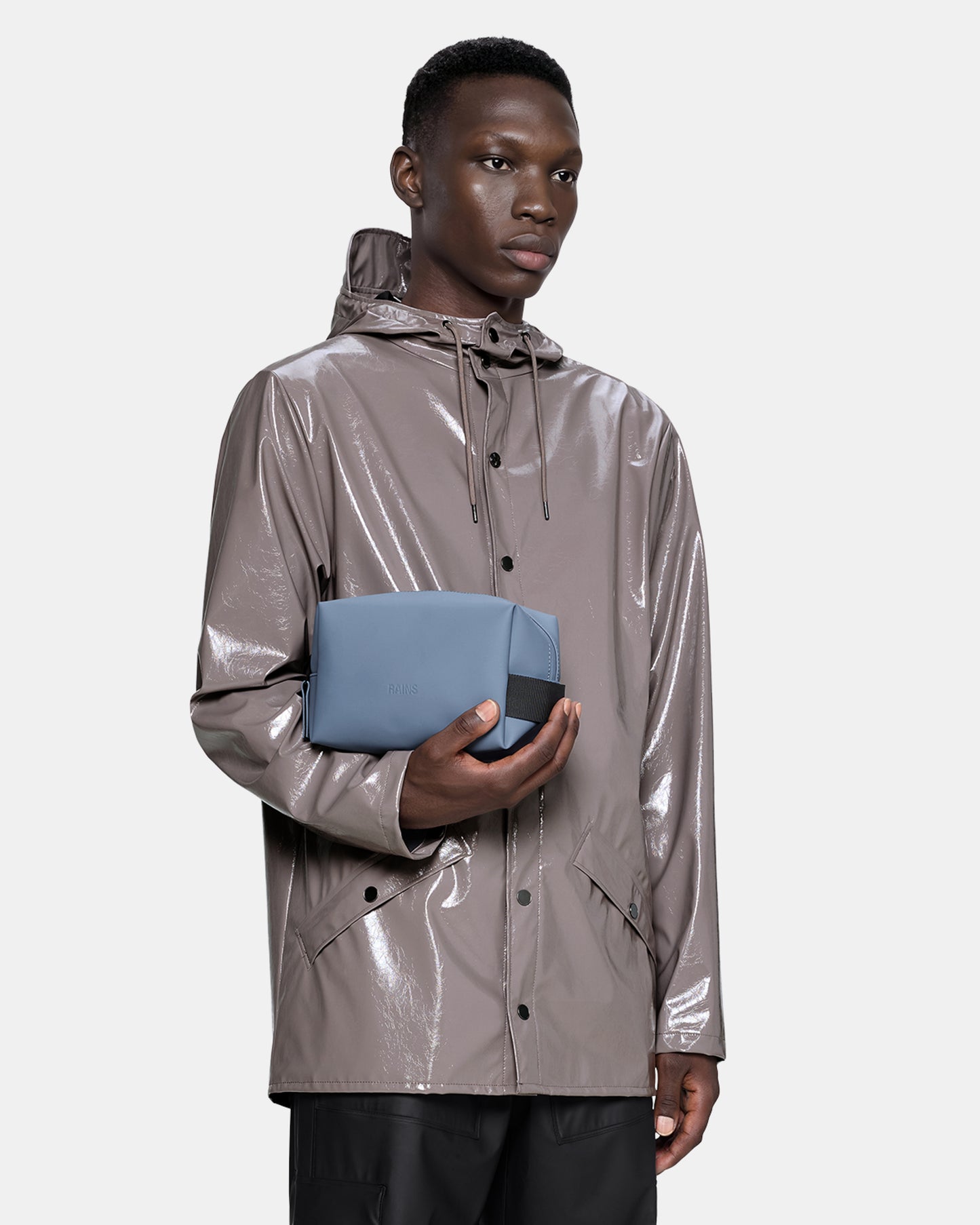 model holding a Rains Wash Bag Small in 172 Blue Dusk