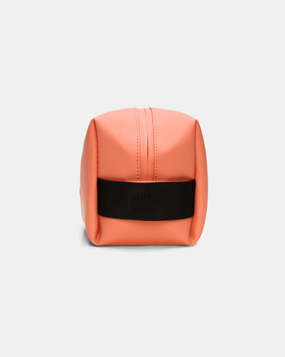 side of a Rains Wash Bag Small in 174 Ember