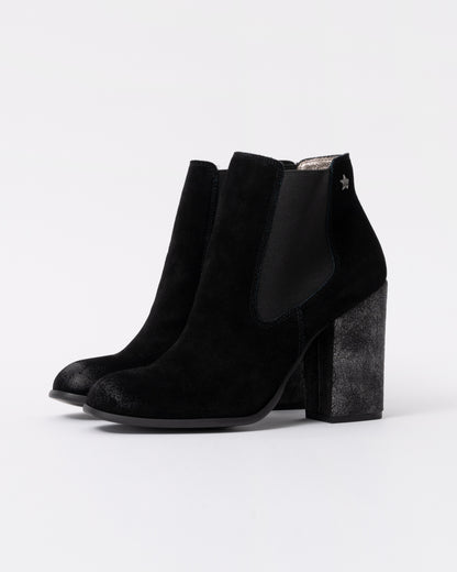 Black ankle boots with a block heel on a white background