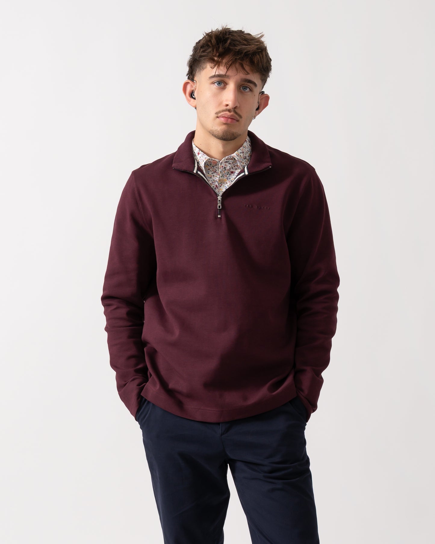Model wearing a Ted Baker Actos Mens 1/4 Zip Sweatshirt in Maroon