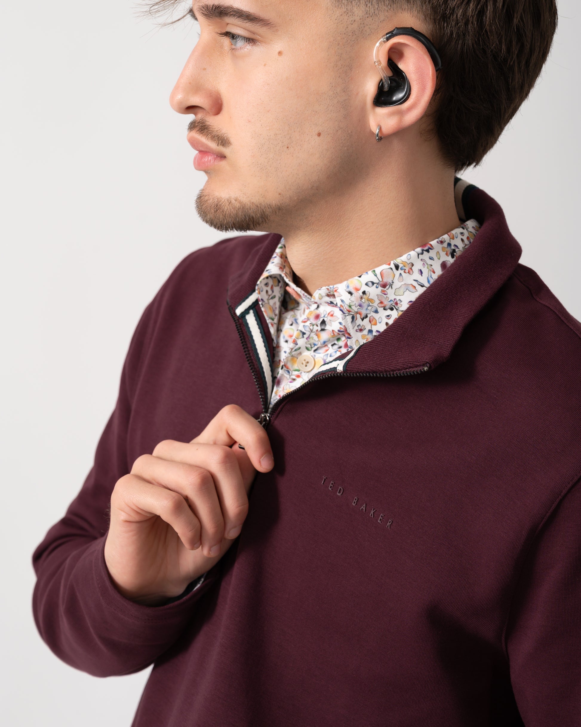 collar detail shot of a Model wearing a Ted Baker Actos Mens 1/4 Zip Sweatshirt in Maroon