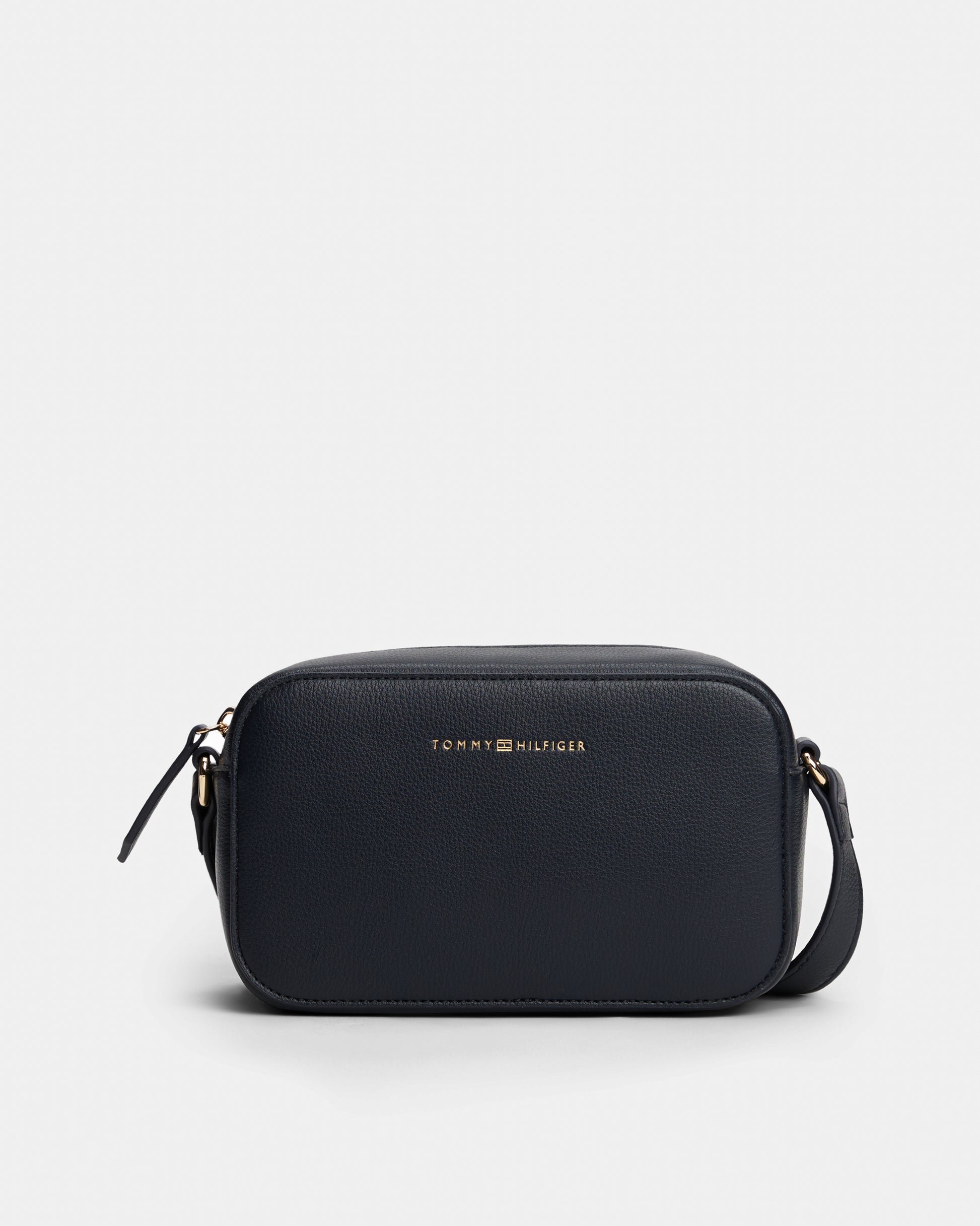 Black crossbody bag with Tommy Hilfiger logo on a light grey background