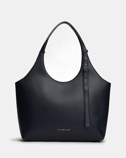 Navy handbag with a visible Tommy Hilfiger logo on a light gray background