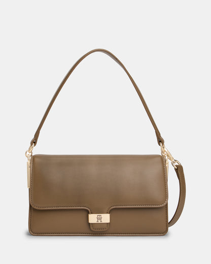 Brown Tommy Hilfiger handbag with a gold clasp on a light grey background