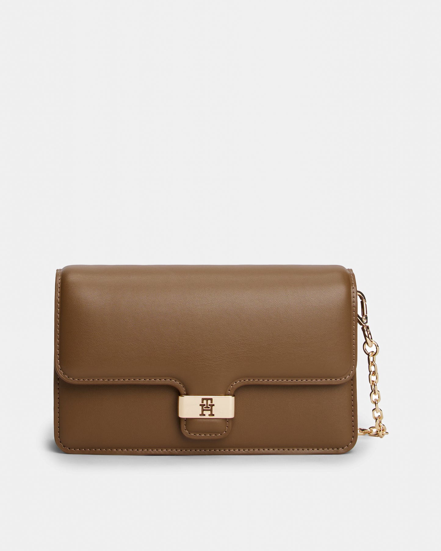 Brown Tommy Hilfiger handbag with a gold chain on a light grey background