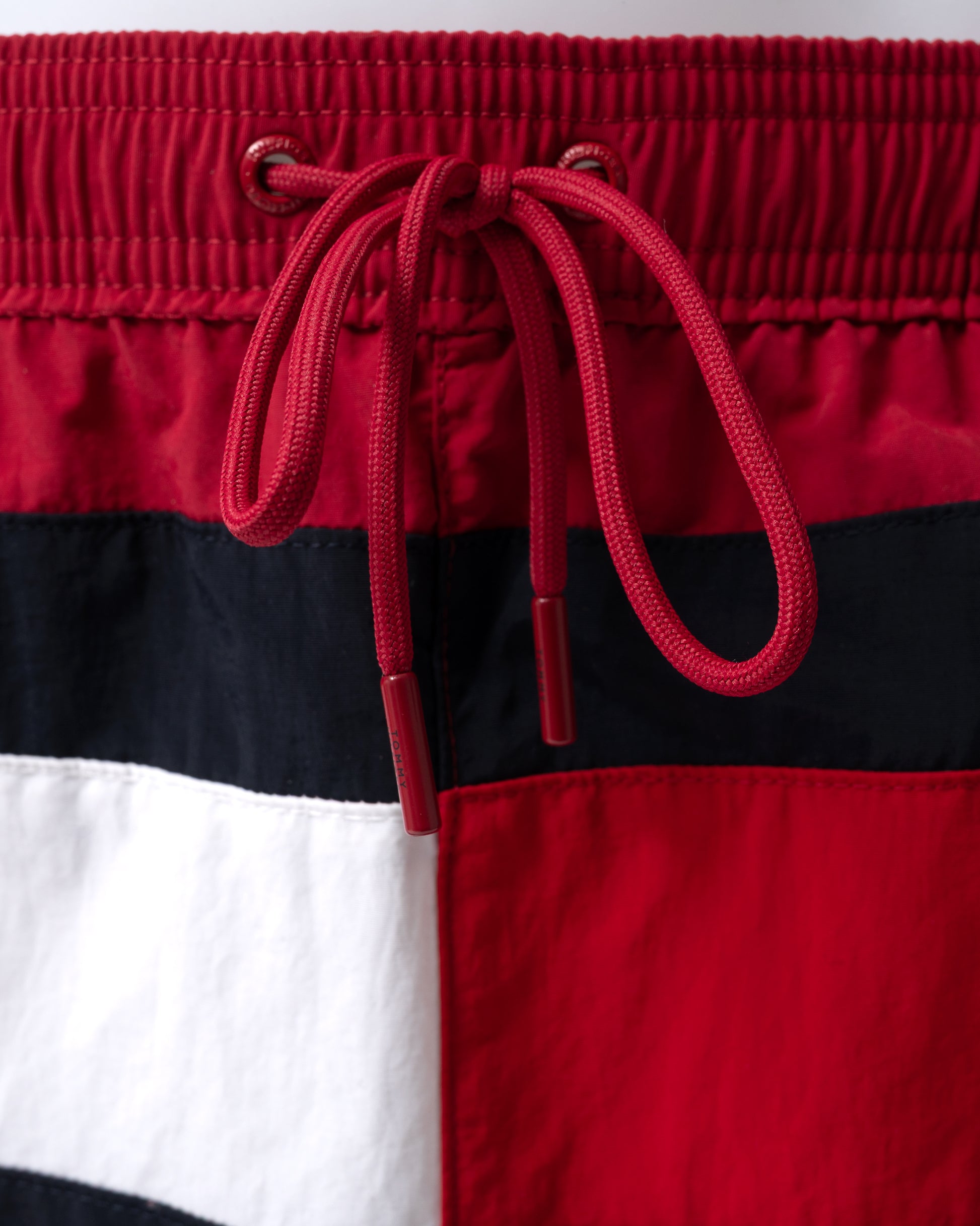close up of Tommy Hilfiger Flag Band Mens Drawstring Swimming Shorts in Raspberry Juice