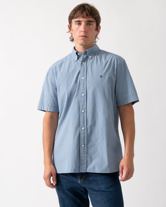 model wearing a Tommy Hilfiger GMD Poplin Mens Short Sleeve Shirt in Brisk Blue