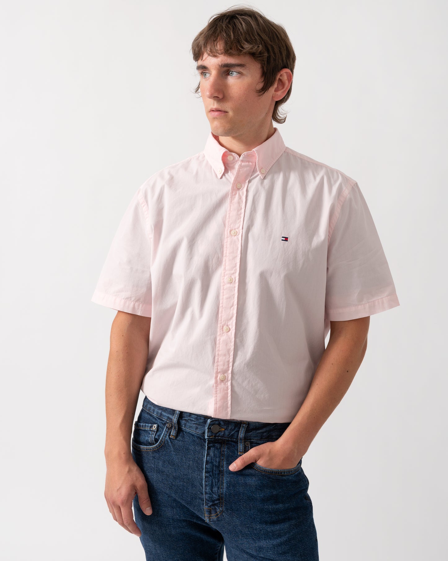model wearing a Tommy Hilfiger GMD Poplin Mens Short Sleeve Shirt in Pink Lily