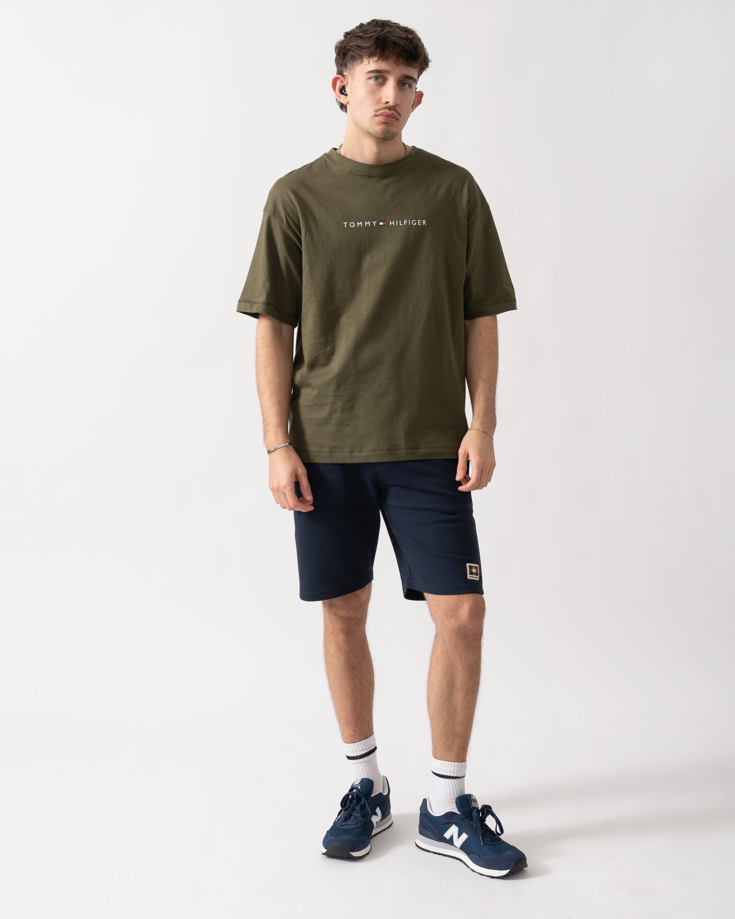 full length shot of a model wearing a Tommy Hilfiger Logo Mens Lounge Tee in Army Green