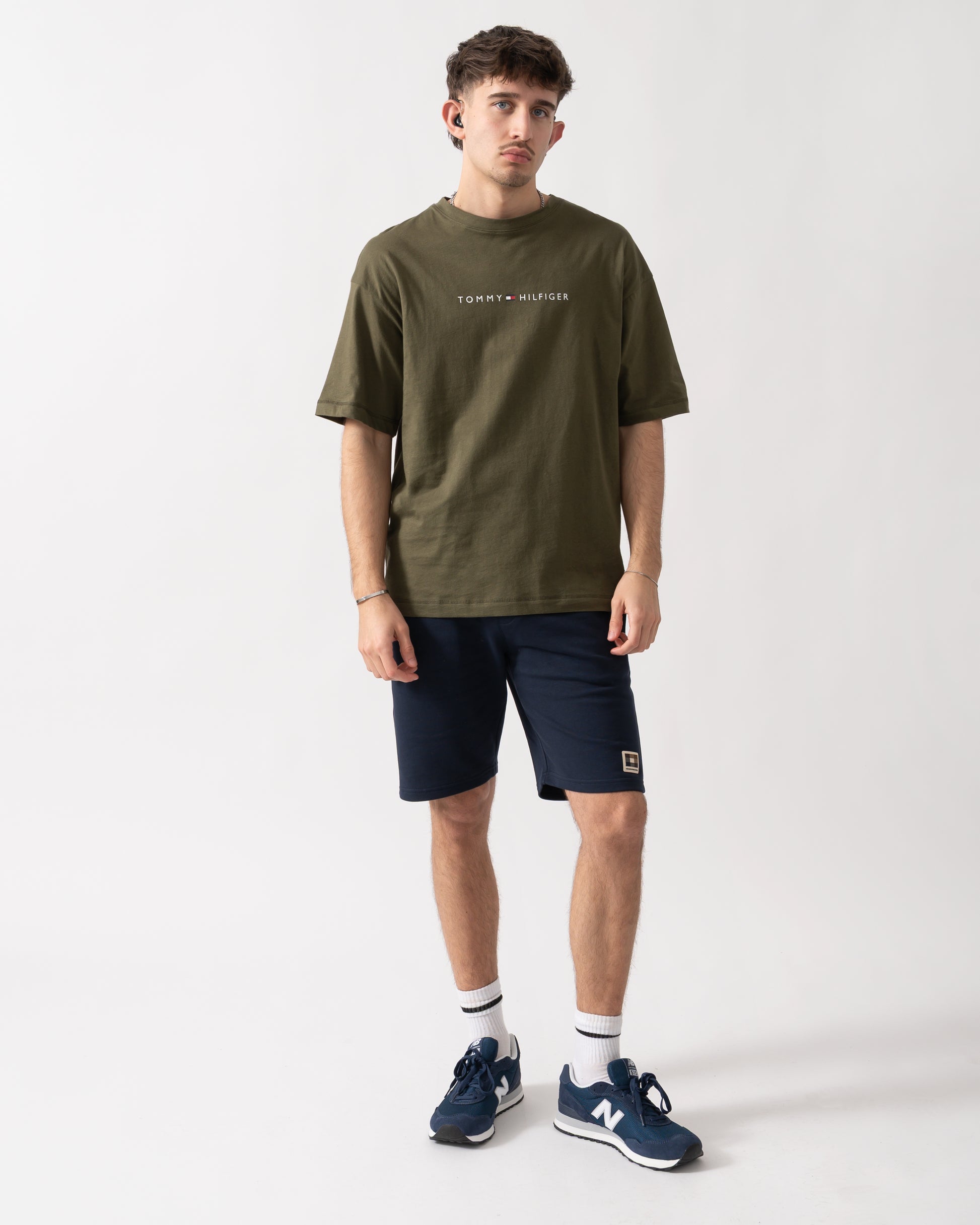 full length shot of a model wearing a Tommy Hilfiger Logo Mens Lounge Tee in Army Green