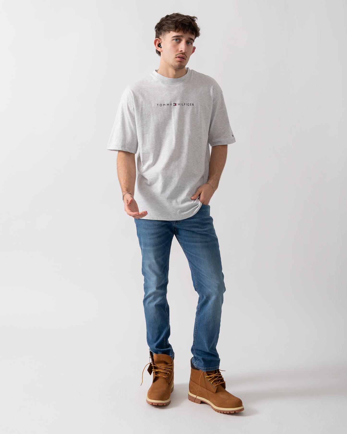 full length shot of a model wearing a Tommy Hilfiger Logo Mens Lounge Tee in Ice Grey Heather