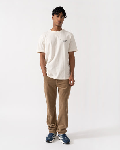 Model wearing the Tommy Hilfiger Mens Back Text Seasonal Graphic T-Shirt - Ivory Petal