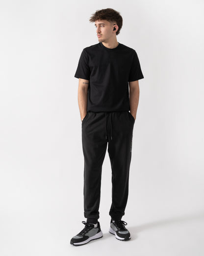full length shot of a model wearing Tommy Hilfiger Mens Track Joggers in Black
