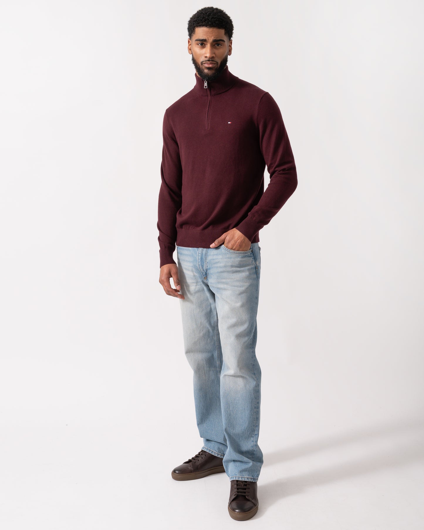 full length shot of a model wearing a Tommy Hilfiger Organic Cotton Cashmere Mens Zip-Mock Sweater in Deep Burgundy