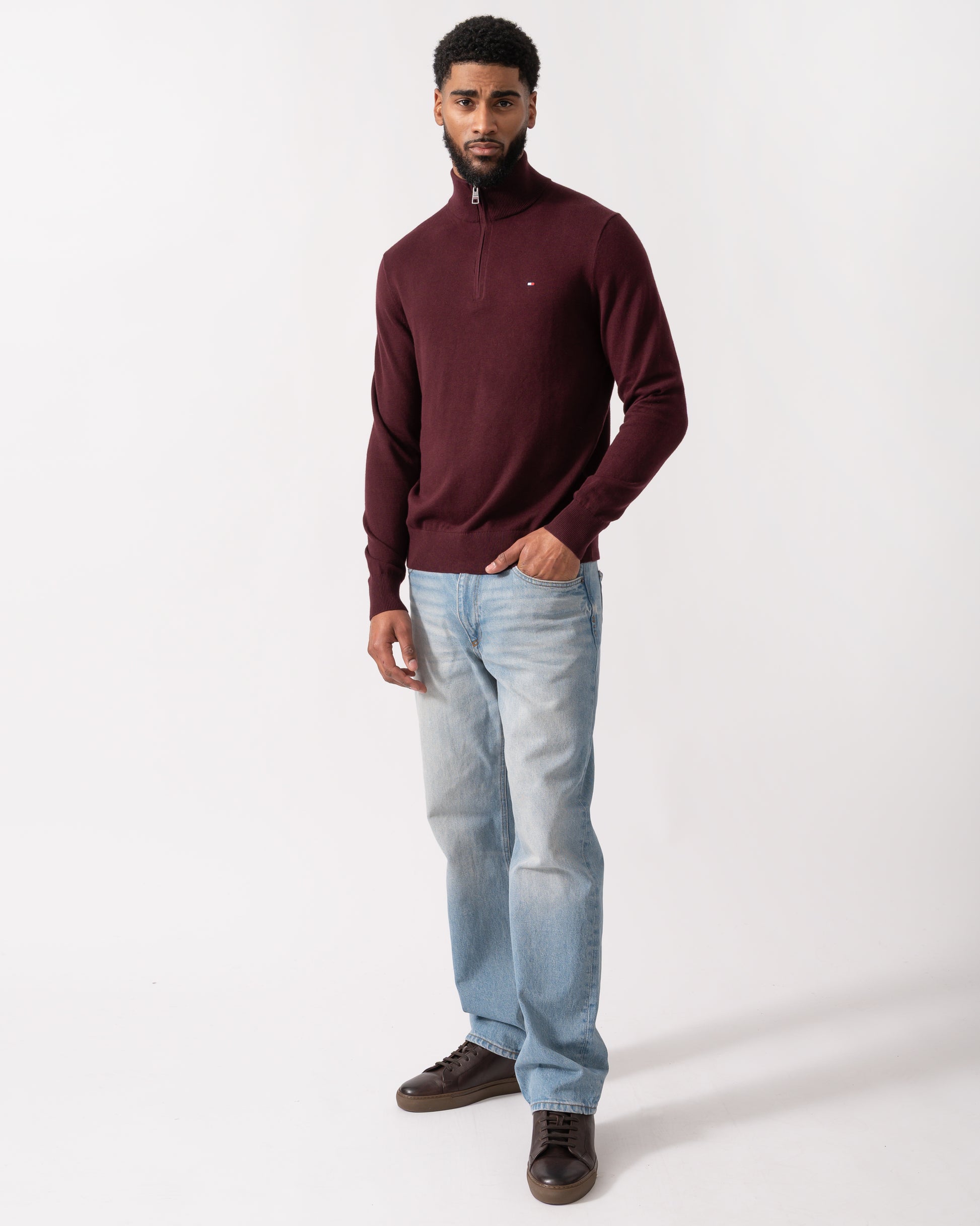 full length shot of a model wearing a Tommy Hilfiger Organic Cotton Cashmere Mens Zip-Mock Sweater in Deep Burgundy