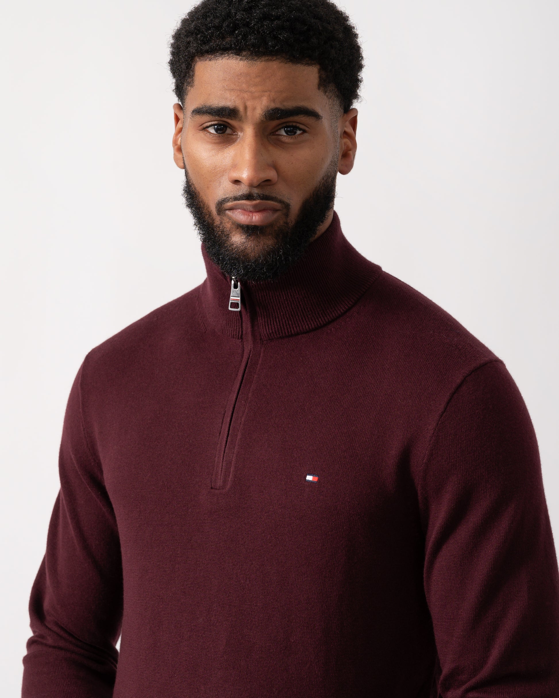 close up of a model wearing a Tommy Hilfiger Organic Cotton Cashmere Mens Zip-Mock Sweater in Deep Burgundy