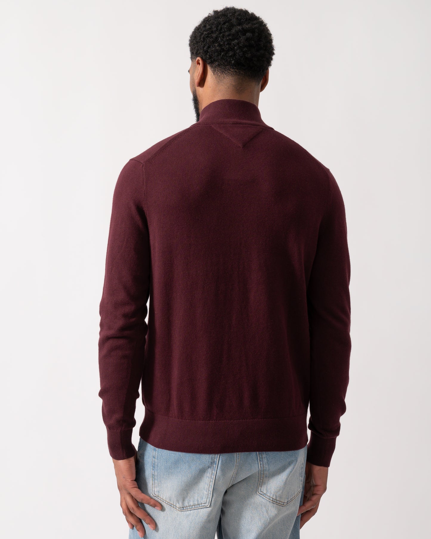 back shot of a model wearing a Tommy Hilfiger Organic Cotton Cashmere Mens Zip-Mock Sweater in Deep Burgundy