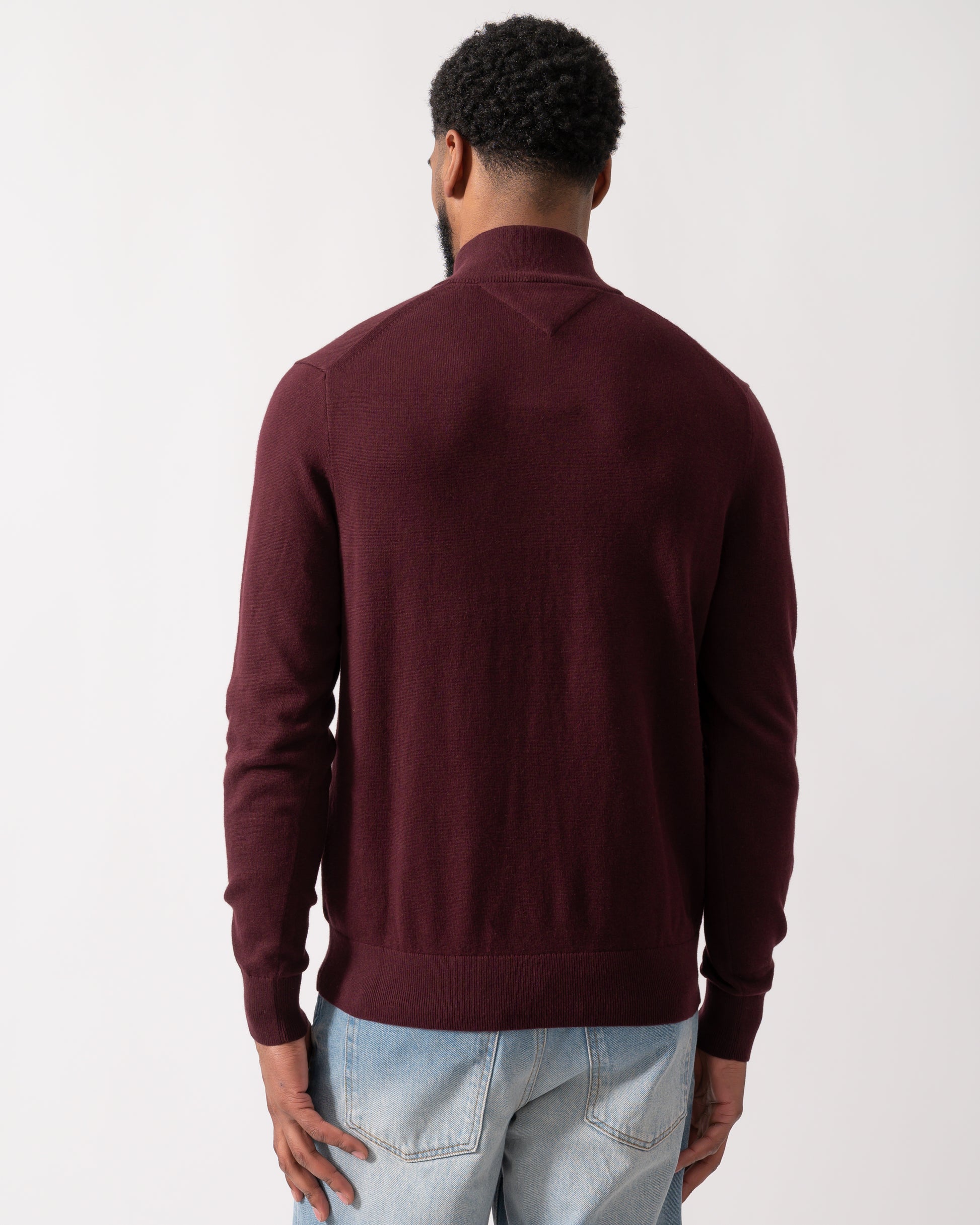back shot of a model wearing a Tommy Hilfiger Organic Cotton Cashmere Mens Zip-Mock Sweater in Deep Burgundy