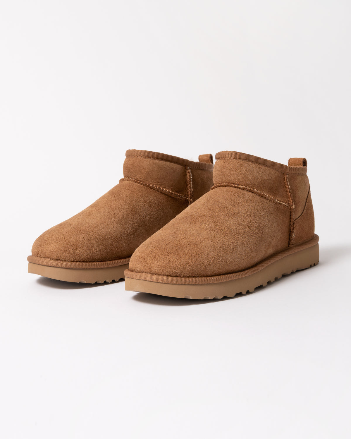 a pair of UGG Classic Ultra Mini Womens Boot in Chestnut