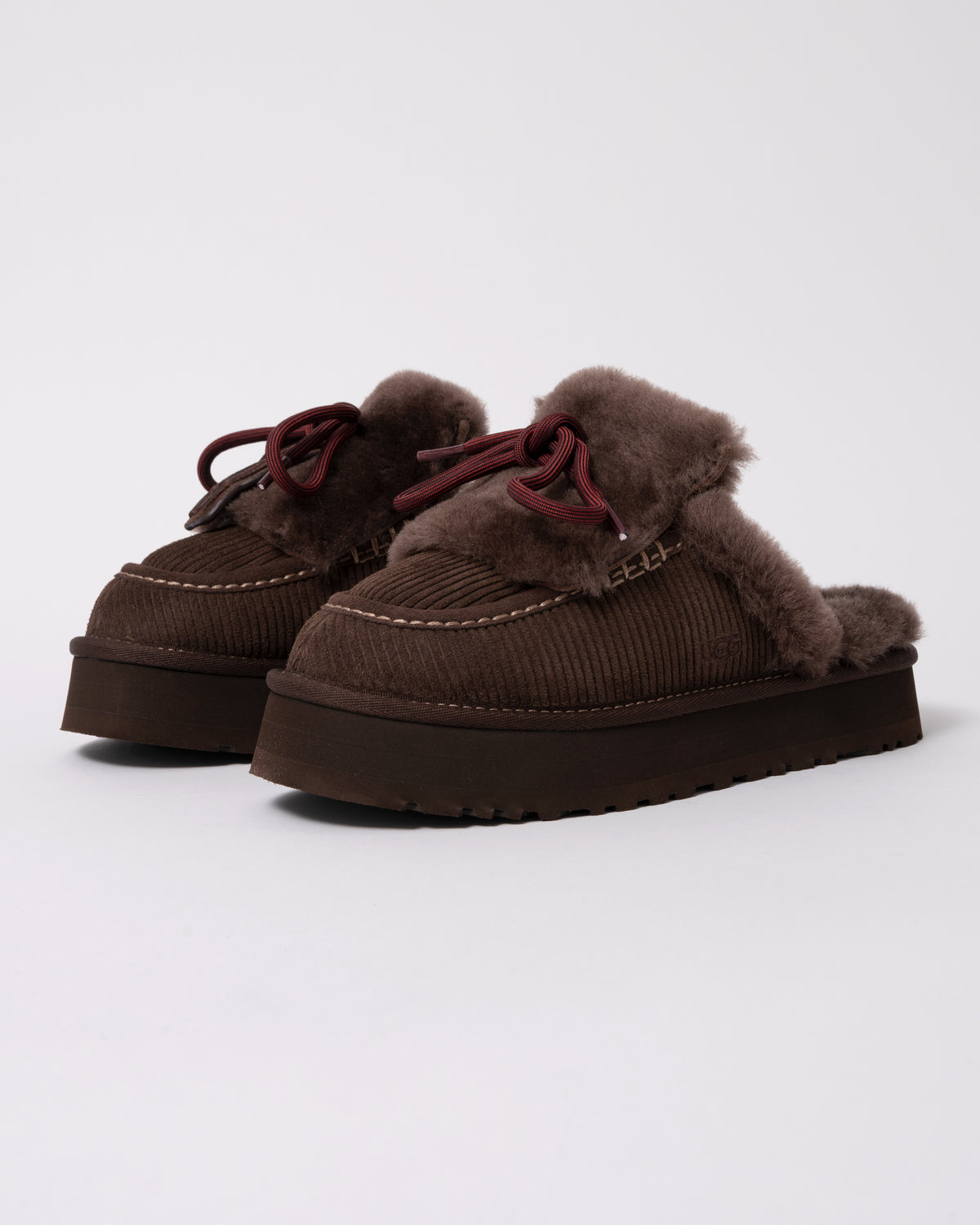 Studio photograph showing UGG Womens Disquette Heritage Slippers in Burnt Cedar