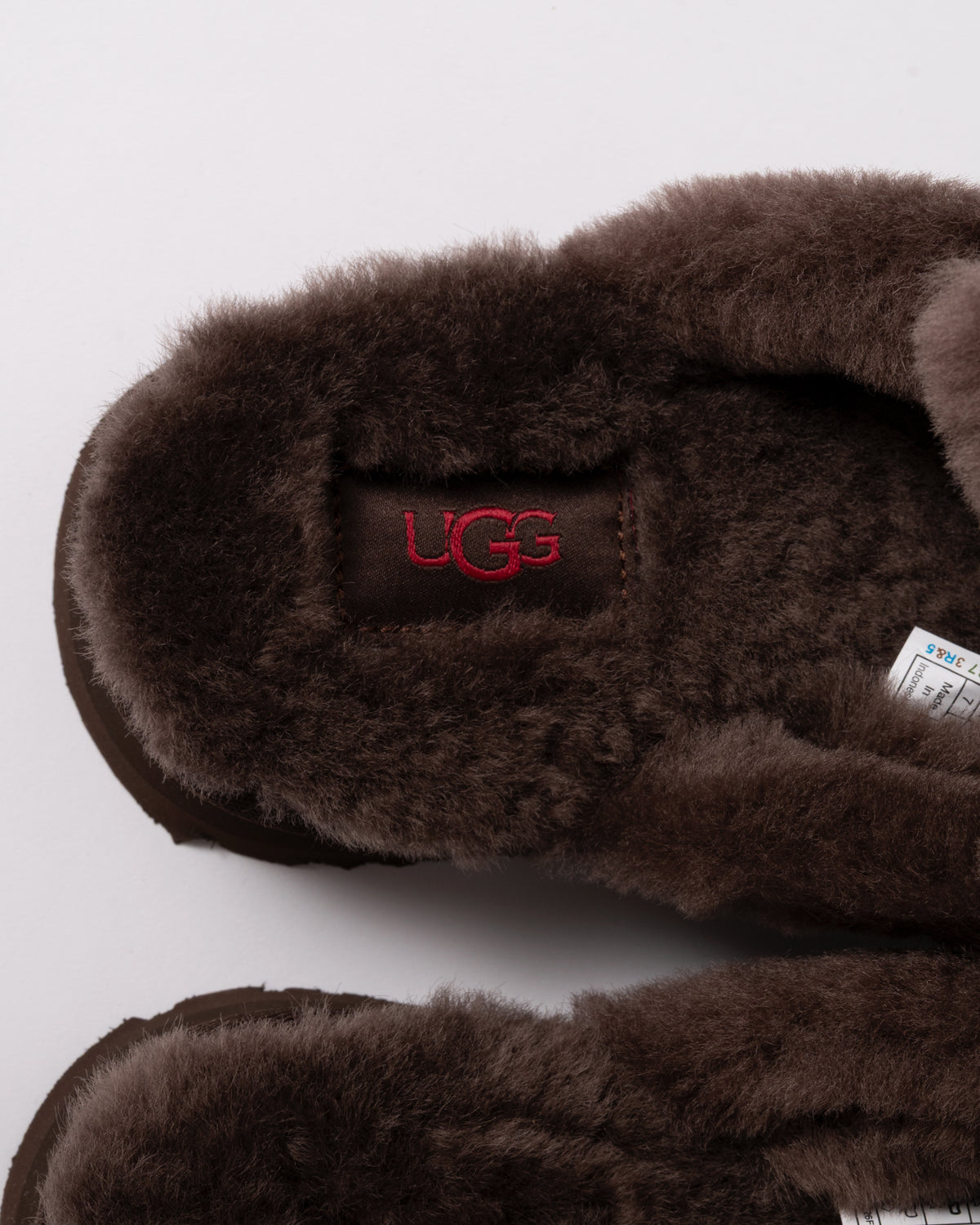 Studio photograph showing inside of UGG Womens Disquette Heritage Slippers in Burnt Cedar
