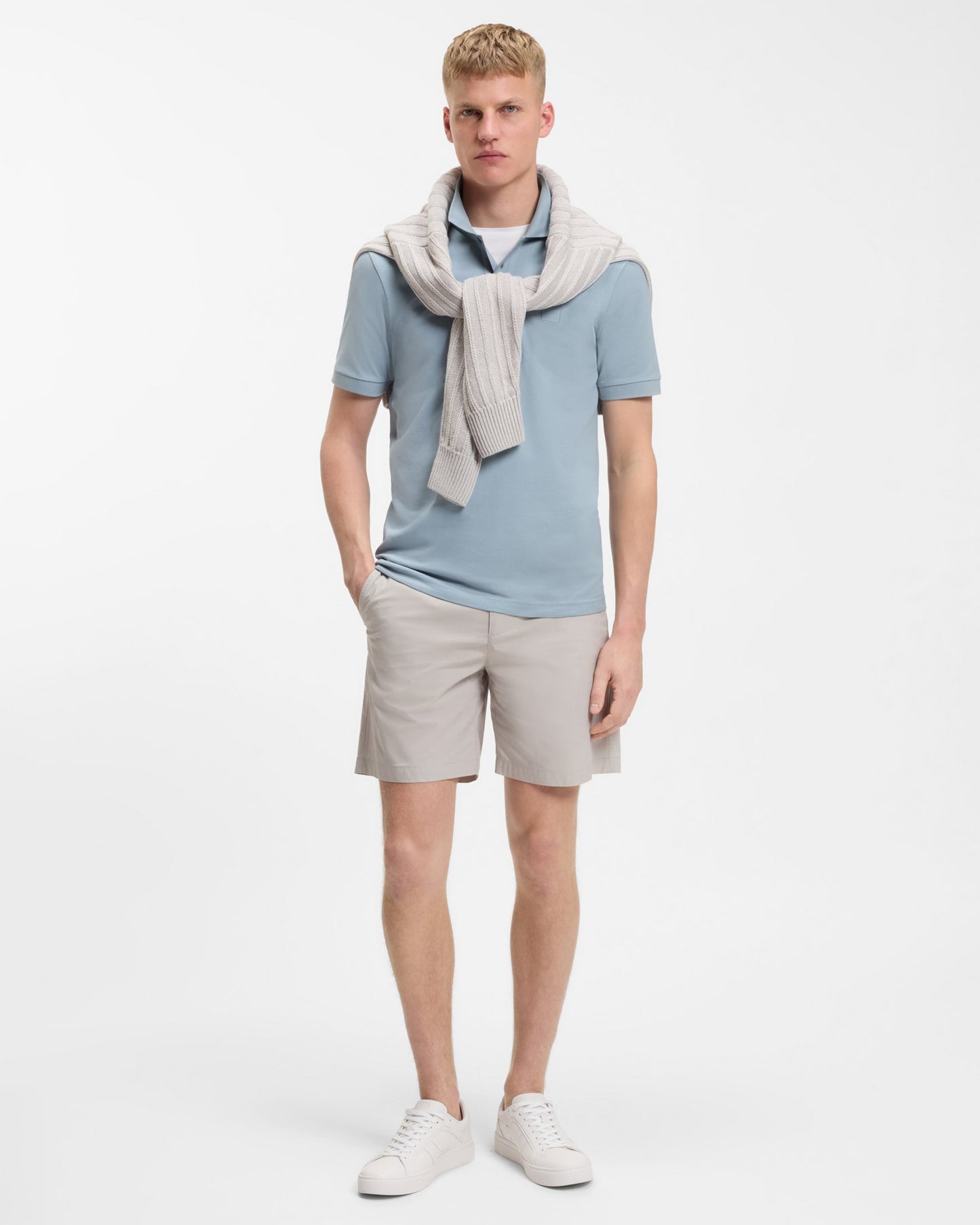 Model wearing BOSS Orange Passenger Mens Stretch-Cotton Slim-Fit Polo Shirt with Logo Patch in Light/Pastel Blue 458 - Full length