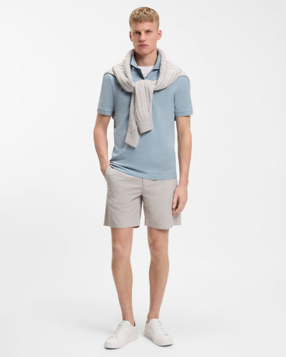 Model wearing BOSS Orange Passenger Mens Stretch-Cotton Slim-Fit Polo Shirt with Logo Patch in Light/Pastel Blue 458 - Full length