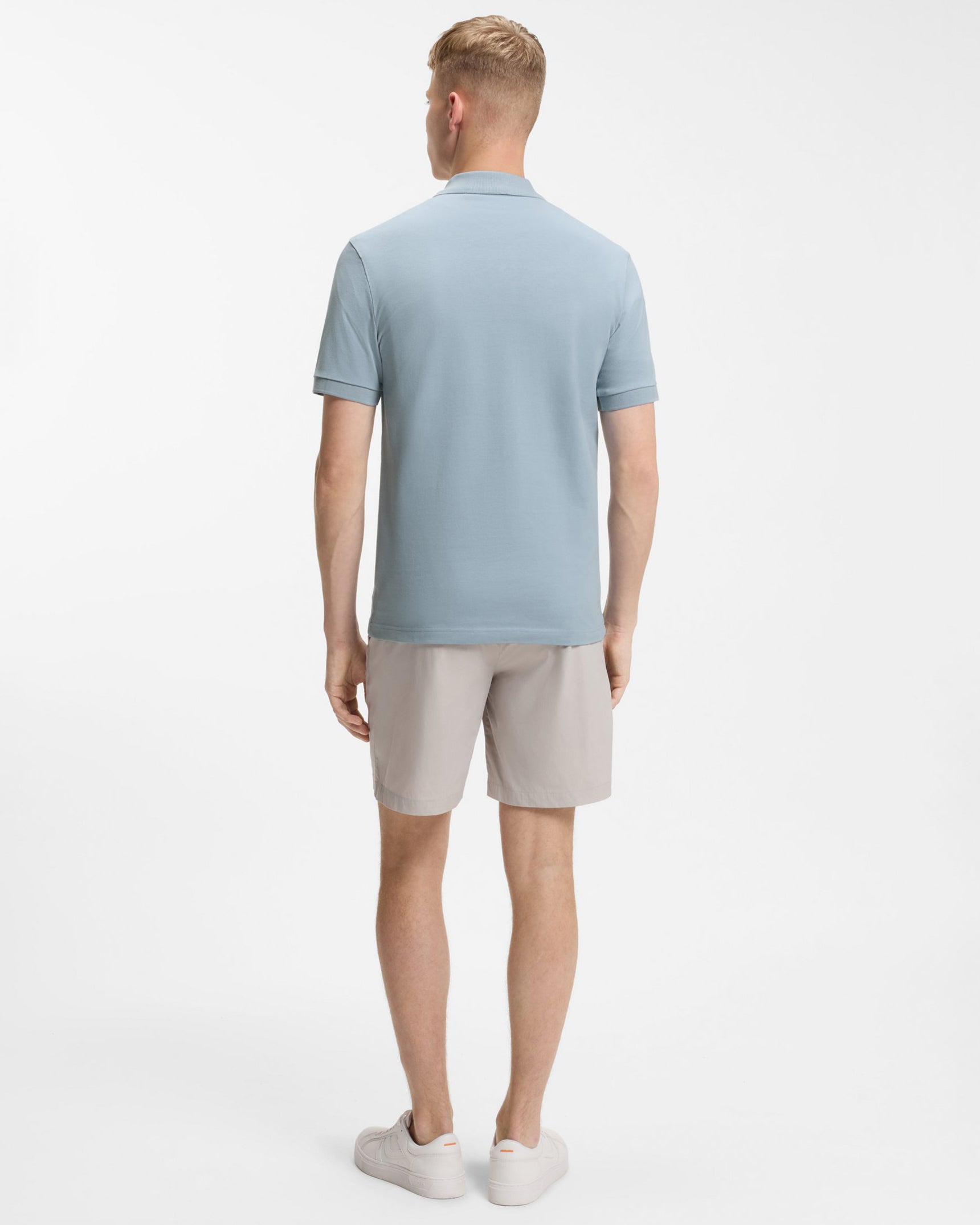 Model wearing BOSS Orange Passenger Mens Stretch-Cotton Slim-Fit Polo Shirt with Logo Patch in Light/Pastel Blue 458 - Back
