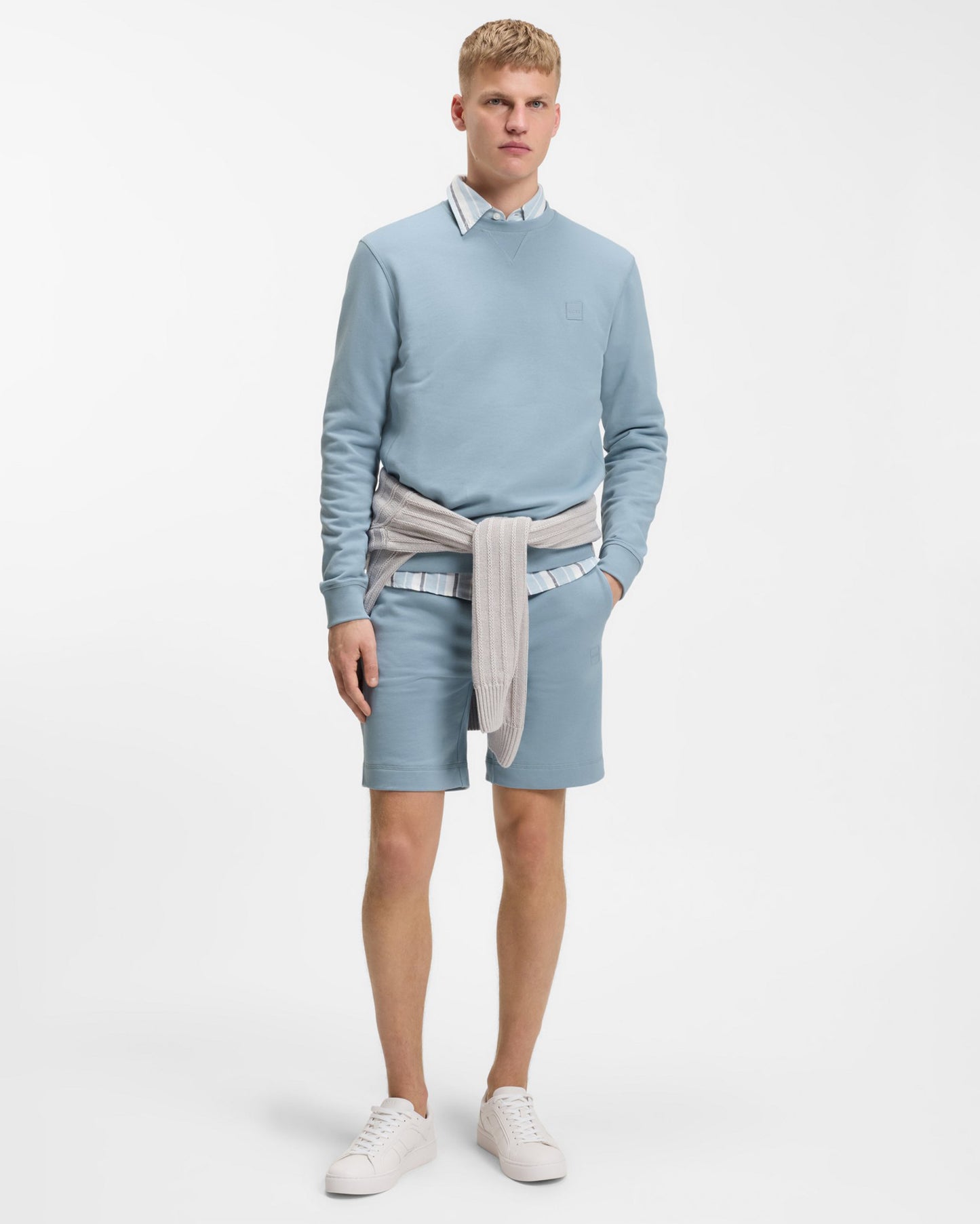 Model wearing BOSS Orange Westart Mens Crew Neck Sweatshirt With Logo Patch in Light/Pastel Blue 458 - Full length