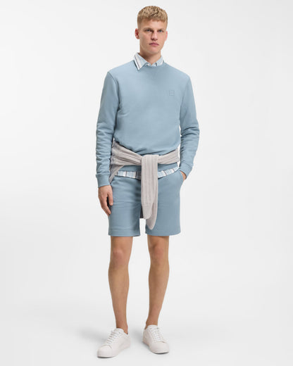 Model wearing BOSS Orange Westart Mens Crew Neck Sweatshirt With Logo Patch in Light/Pastel Blue 458 - Full length