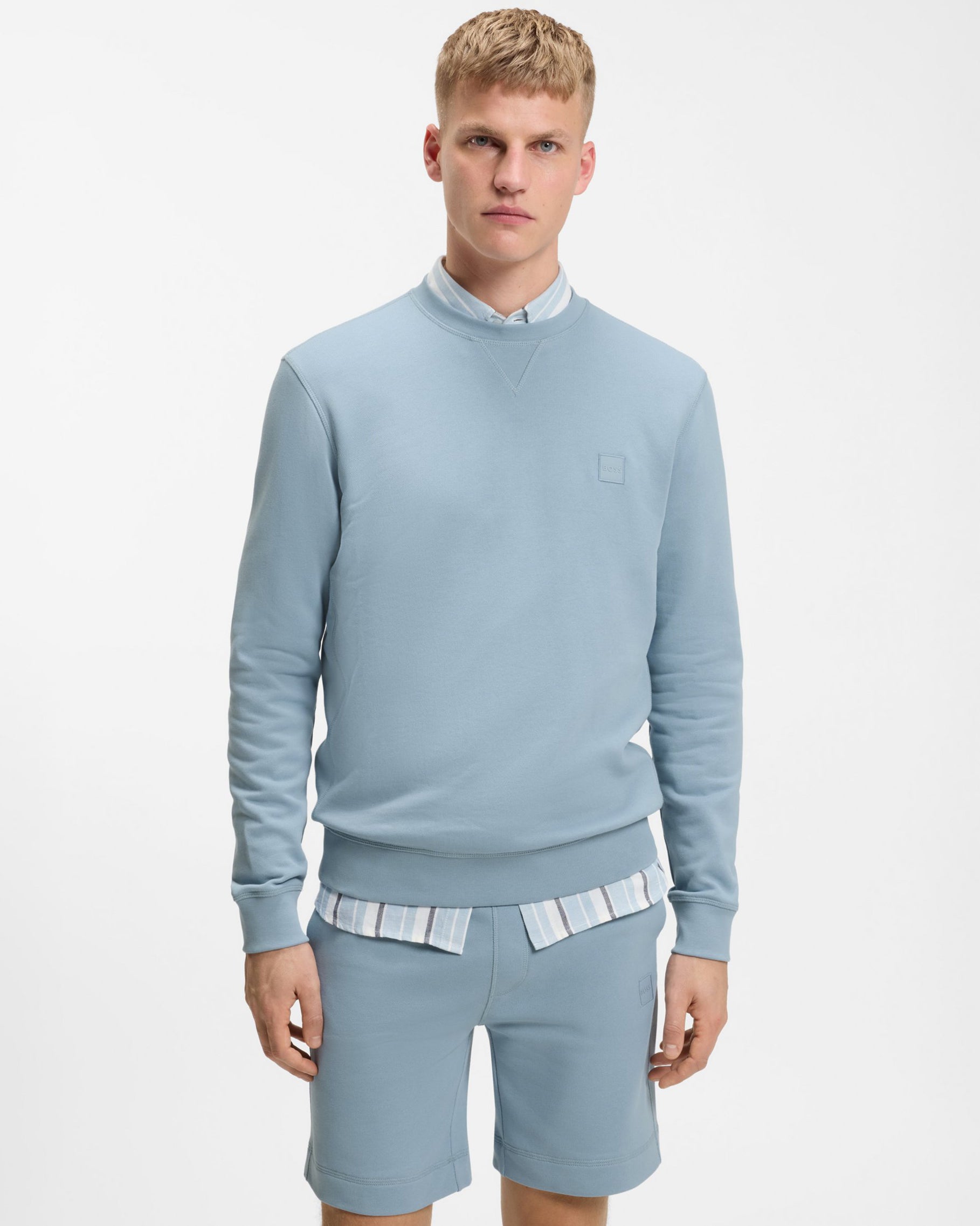 Model wearing BOSS Orange Westart Mens Crew Neck Sweatshirt With Logo Patch in Light/Pastel Blue 458 - Front