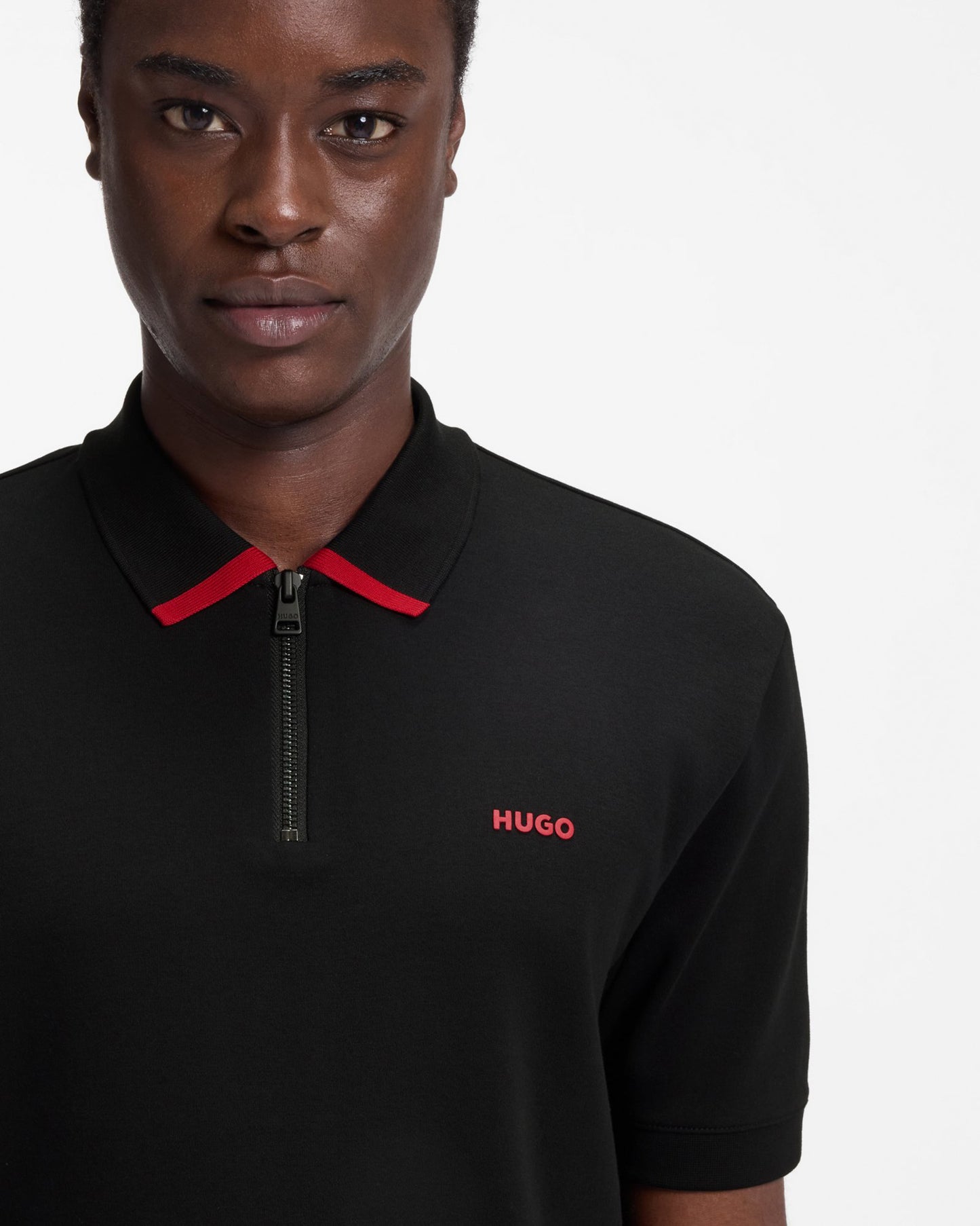 Model wearing HUGO Dalomino Mens Short Sleeve Zip Placket Polo Shirt with Contrast Logo in Black 002 - Close up