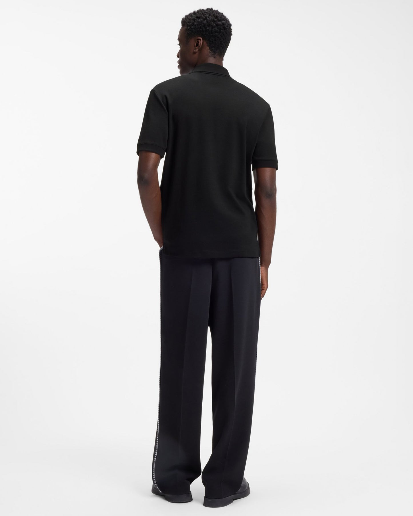 Model wearing HUGO Dalomino Mens Short Sleeve Zip Placket Polo Shirt with Contrast Logo in Black 002 - Back