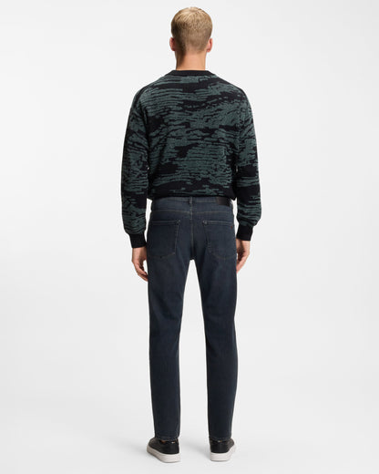 Model wearing BOSS Orange ReMaine Mens Jeans 50555289 in Dark Blue 408 - Back