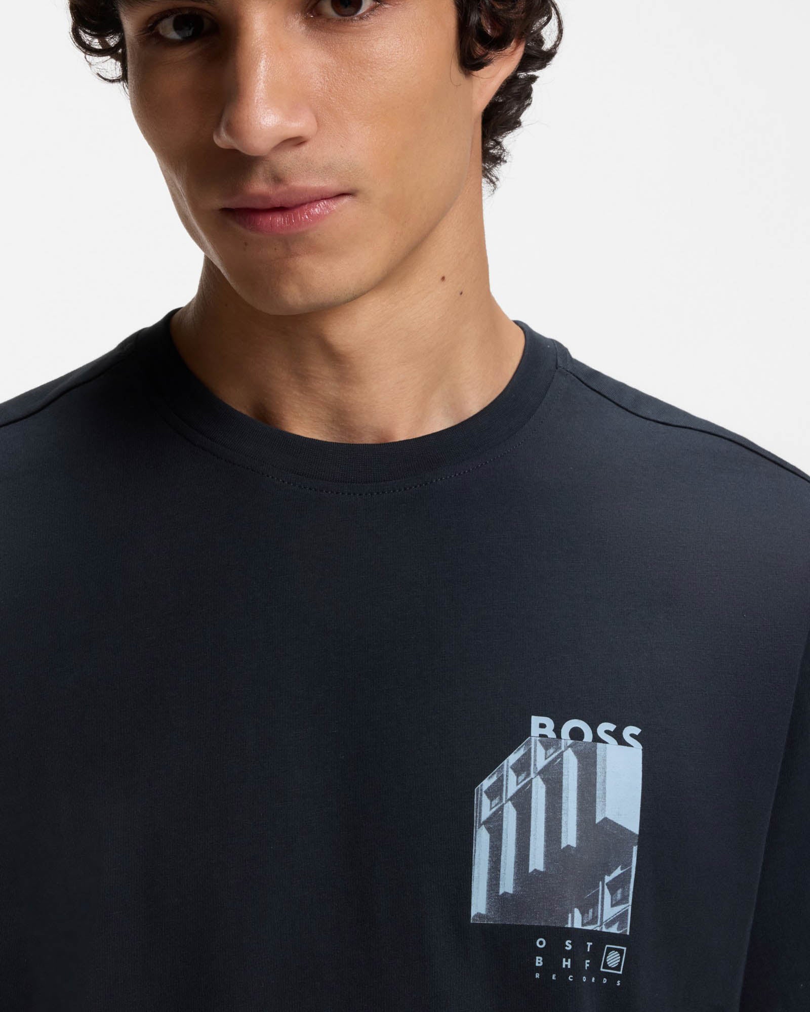 Model wearing BOSS Orange Te Board Mens T-Shirt in Dark Blue 404 - Close up
